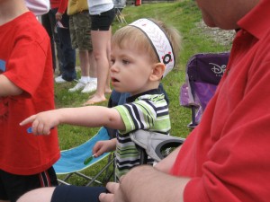 Quin pointing at one of the many fire trucks in the Memorial Day parade.